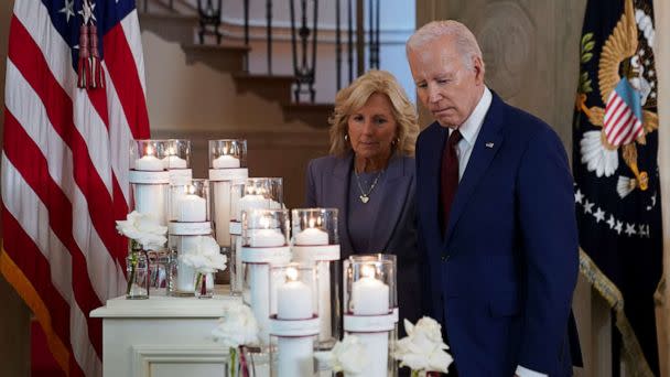 PHOTO: President Joe Biden and first lady Jill Biden pause to look at a display of candles a year after the school shooting at Robb Elementary School in Uvalde, Texas, during an event at the White House, May 24, 2023. (Kevin Lamarque/Reuters)
