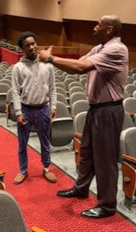 Tim Jackson talks to a student at McKinley High School.