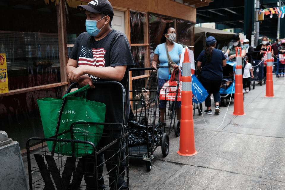 NEW YORK, NEW YORK - JUNE 04: People receive food from a local charity in the Queens borough of New York City on June 04, 2021 in New York City. The U.S. economy added 559,000 jobs in May, bringing the unemployment rate down to 5.8 percent from 6.1 percent. Despite the positive economic news, millions of Americans are still looking for work or are in need of financial, food, and housing assistance. (Photo by Spencer Platt/Getty Images)