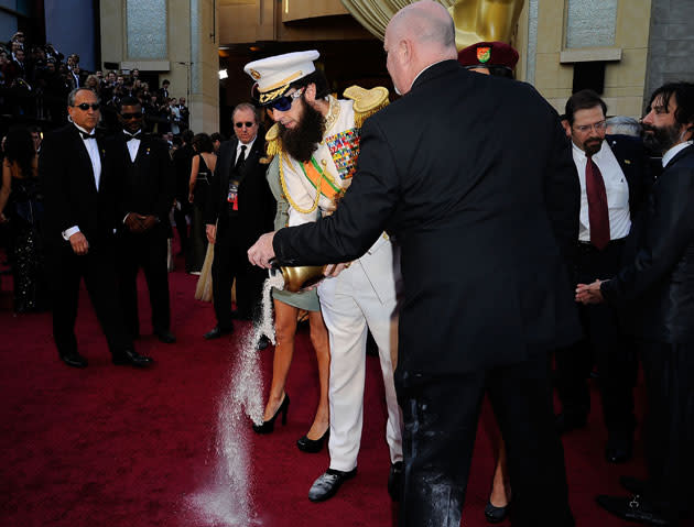 <b>Oscars 2012: Red carpet photos</b><br><br><b>Sacha Baron Cohen</b> pours 'ashes' on the red carpet.<br><br><b>[Related story: </b><a href="http://uk.movies.yahoo.com/blogs/editors-20111013/oscars-2012-sacha-baron-cohen-shows-dictator-001008637.html" data-ylk="slk:Sacha Baron Cohen causes a scene on the red carpet;elm:context_link;itc:0;sec:content-canvas;outcm:mb_qualified_link;_E:mb_qualified_link;ct:story;" class="link  yahoo-link">Sacha Baron Cohen causes a scene on the red carpet</a> <b>]</b>