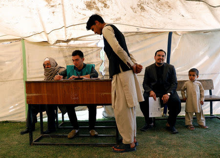 Afghan men arrive at a voter registration centre to register for the upcoming parliamentary and district council elections in Kabul, Afghanistan April 23, 2018. REUTERS/Mohammad Ismail