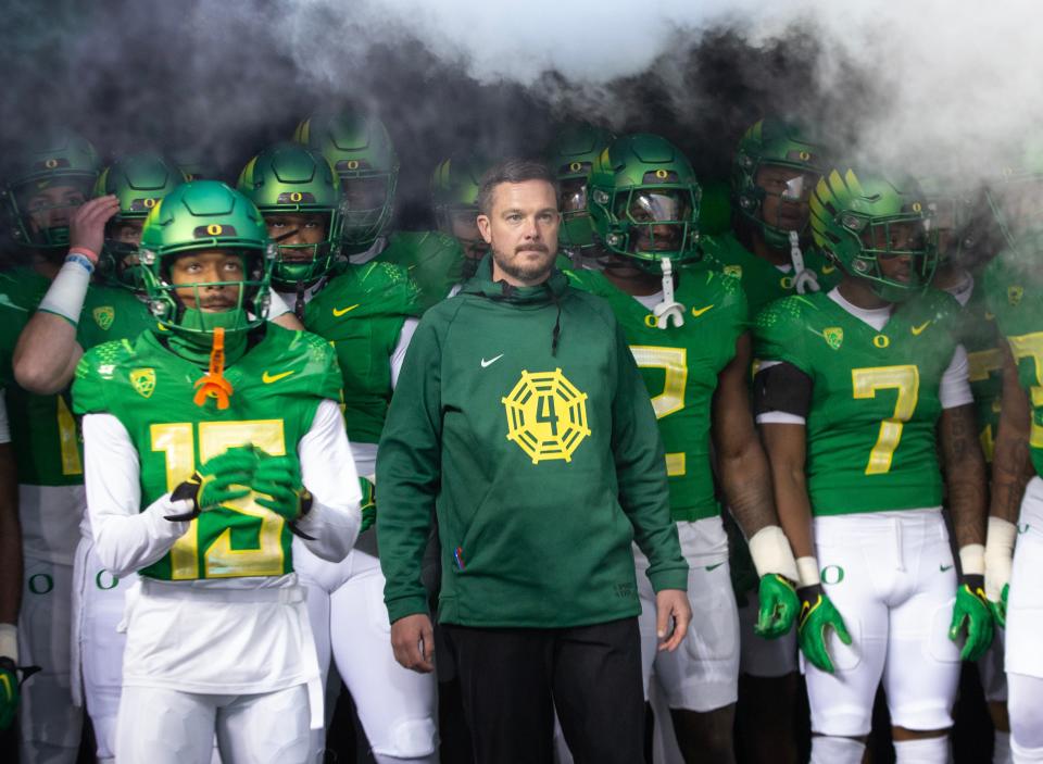 Oregon head coach Dan Lanning, center, waits to take the field with his team for their game against Oregon State at Autzen Stadium in November 2023.