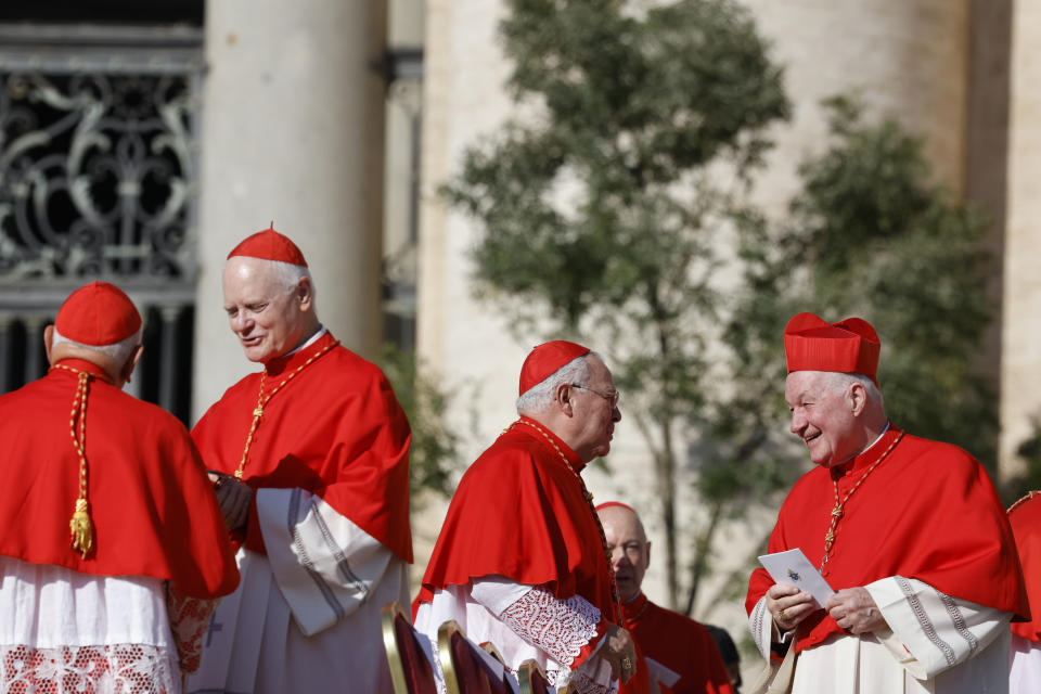 Dean of the College of Cardinals, Cardinal Giovanni Battista Re, third from left, and other cardinals talk among each other as they wait for a consistory to start in St. Peter's Square at The Vatican where Pope Francis will create 21 new cardinals, Saturday, Sept. 30, 2023. (AP Photo/Riccardo De Luca)