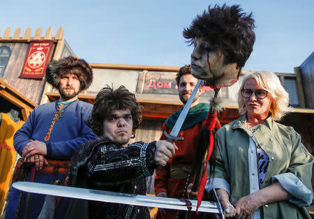 An actor dressed as Tyrion Lannister, poses for photographers with fake severed head before the screening of final episode of Game of Thrones on 20-meter-high screen at RZD Arena in Moscow, Russia May 20, 2019. REUTERS/Maxim Shemetov