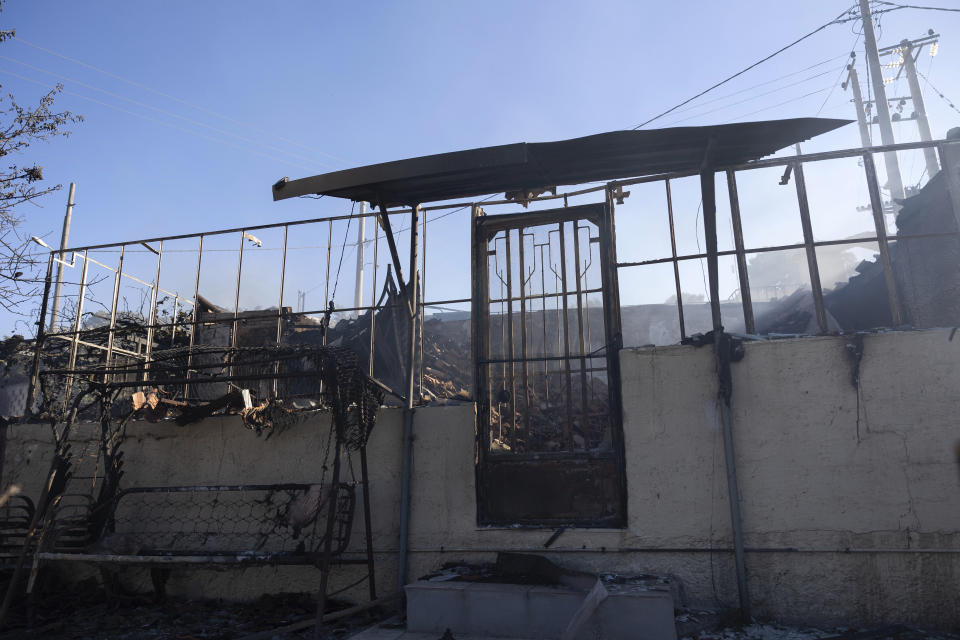 The remains of a home are pictured after a forest fire at Keratea area, southeast of Athens, Greece, Sunday, June 30, 2024. Two large wildfires were burning Sunday near Greece's capital of Athens, and authorities sent emergency messages for some residents to evacuate and others to stay at home and close their windows to protect themselves from smoke. (AP Photo/Yorgos Karahalis)