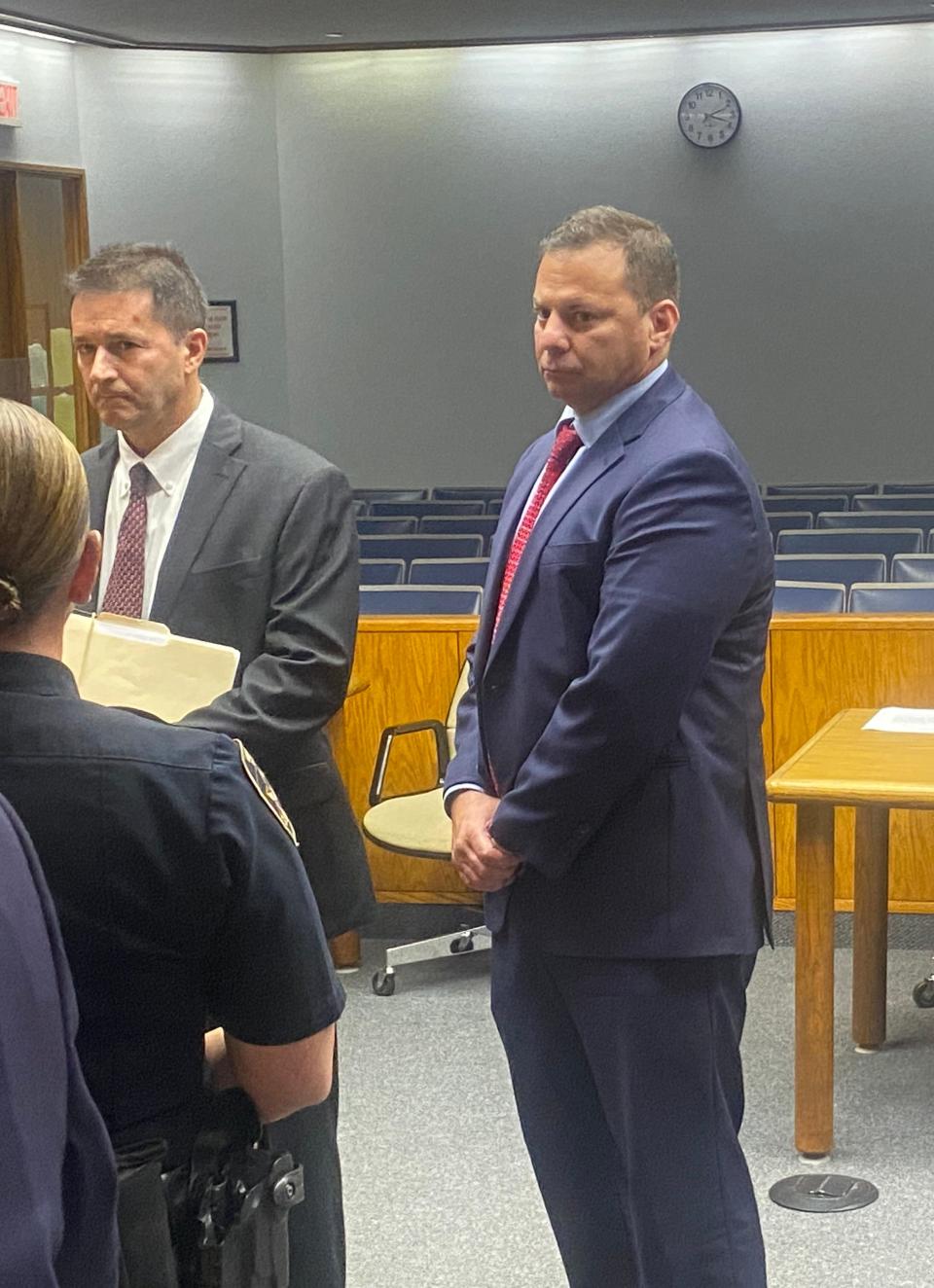 Providence police Capt. Stephen J. Gencarella, right, appears Thursday in District Court, Providence, where he was arraigned on a charge of simple assault