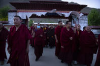 Monks prepare to go to dinner at the Tibetan Buddhist College near Lhasa in western China's Tibet Autonomous Region, Monday, May 31, 2021, as seen during a government organized visit for foreign journalists. High-pressure tactics employed by China's ruling Communist Party appear to be finding success in separating Tibetans from their traditional Buddhist culture and the influence of the Dalai Lama. (AP Photo/Mark Schiefelbein)