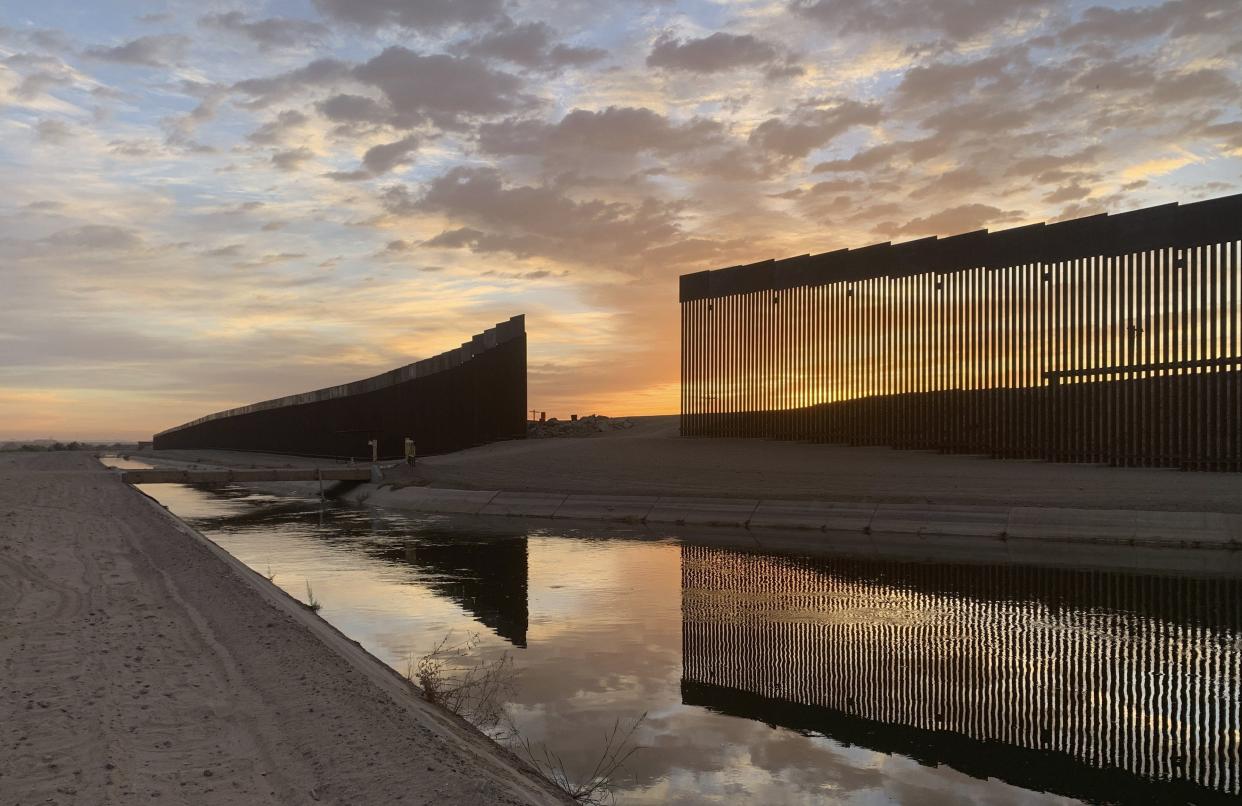 The sun sets above the U.S.-Mexico border wall, seen in Yuma, Ariz., Wednesday, June 9, 2021. The Biden administration says it has identified more than 3,900 children separated from their parents at the U.S.-Mexico border under former President Donald Trump's "zero-tolerance" policy on illegal crossings. The Border Patrol's Yuma sector recorded the highest number of separations of the agency's nine sectors on the Mexican border. (AP Photo/Eugene Garcia)