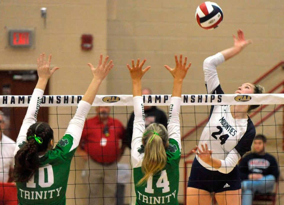 Philipsburg-Osceola’s Reese Hazelton goes up for a kill against Trinity’s Sammie McAuliffe, left, and Adeline Woodward in November 2023.