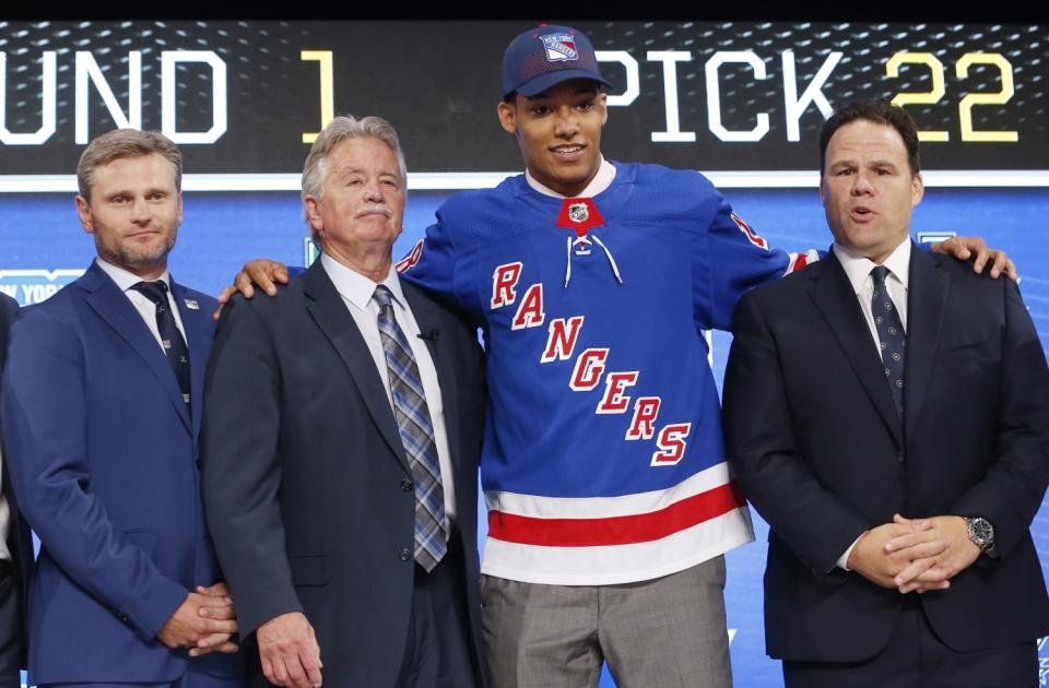 Rangers prospect K'Andre Miller on the stage after being drafted in 2018.