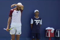 Maxime Cressy, of the United States, pauses to wipe his face during a match against Andrey Rublev, of Russia, at the Citi Open tennis tournament in Washington, Friday, Aug. 5, 2022. (AP Photo/Carolyn Kaster)