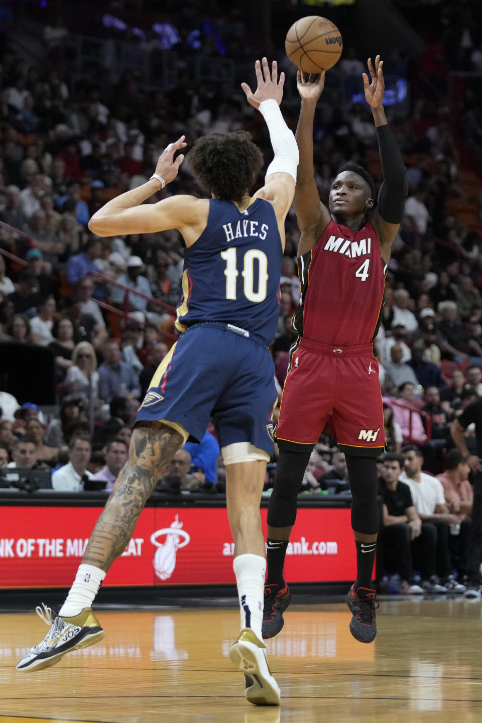 Miami Heat guard Victor Oladipo (4) takes a shot against New Orleans Pelicans center Jaxson Hayes (10) during the first half of an NBA basketball game, Sunday, Jan. 22, 2023, in Miami. (AP Photo/Wilfredo Lee)