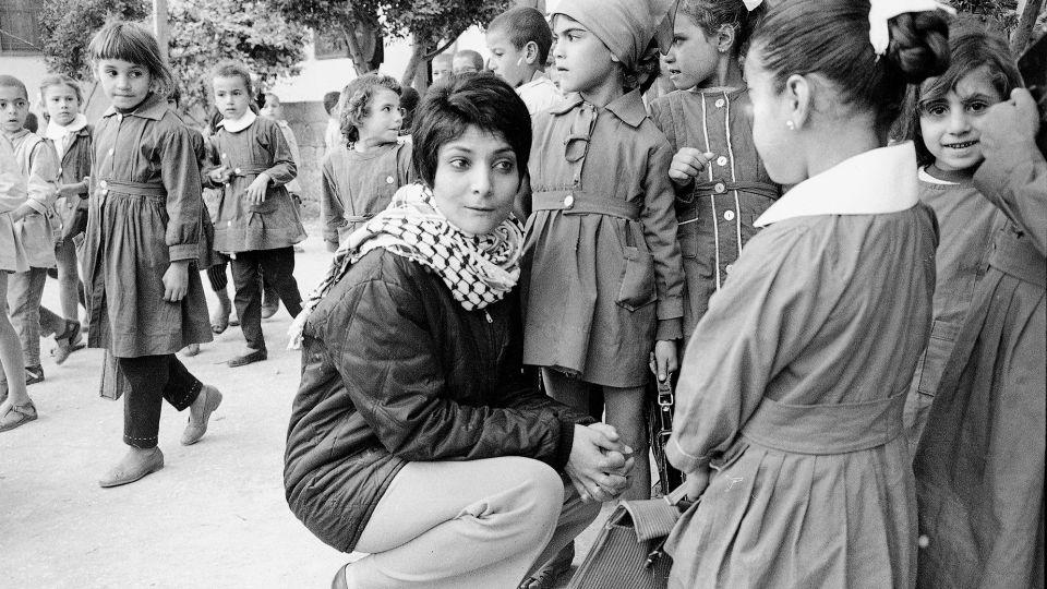 Leila Khaled wears a keffiyeh while visiting a Palestinian refugee camp in 1970. - Harry Koundakjian/AP