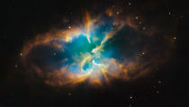 This image provided by the Hubble Space Telescope shows the striking details of the famed planetary nebula designated NGC 2818, which lies in the southern constellation of Pyxis (the Compass). (AP Photo/NASA)