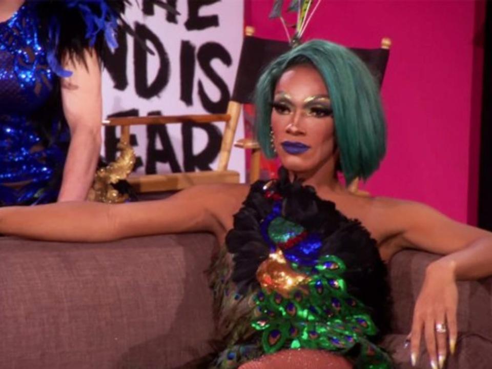 a drag queen sitting on a couch on 'rupaul's drag race untucked'