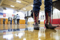 Chief Election Official Sandy Pace wears her patriotic-themed boots while staffing the polling station at Drew Middle School on Election Day in Stafford, Va., Tuesday, Nov. 5, 2019. (Mike Morones/The Free Lance-Star via AP)