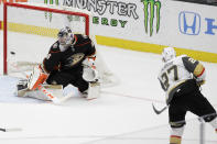 Vegas Golden Knights defenseman Shea Theodore, right, scores the game winning goal past Anaheim Ducks goaltender John Gibson during overtime in an NHL hockey game in Anaheim, Calif., Sunday, Feb. 23, 2020.The Golden Knights won 6-5. (AP Photo/Chris Carlson)