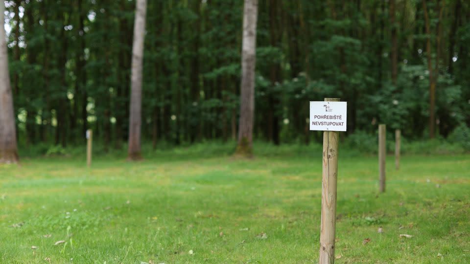 A sign "Burial grounds, do not enter" marks the site of mass graves discovered near the camp. - Ivana Kottasova/CNN