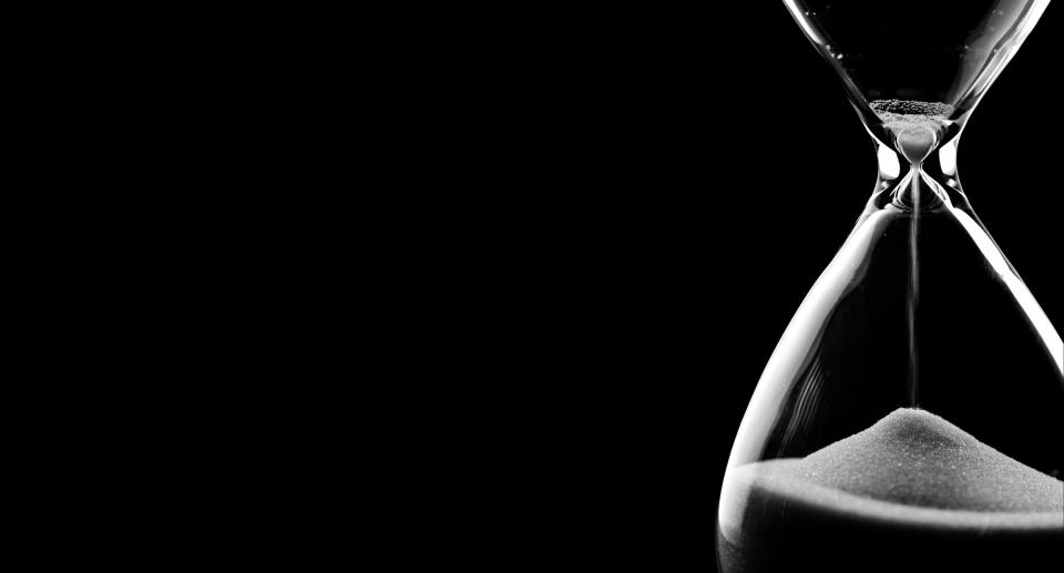 An hourglass on black background.