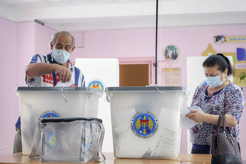 A man casts his vote in a snap parliamentary election, in Chisinau, Moldova, Sunday, July 11, 2021. Moldovan citizens vote in a key snap parliamentary election that could decide whether the former Soviet republic fully embraces pro-Western reform or prolongs a political impasse with strong Russian influence. (AP Photo/Aurel Obreja)