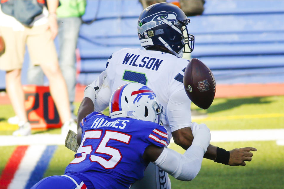 Buffalo Bills' Jerry Hughes (55) knocks the ball away from Seattle Seahawks' Russell Wilson (3) to force a fumble during the second half of an NFL football game Sunday, Nov. 8, 2020, in Orchard Park, N.Y. The Bills recovered the ball. (AP Photo/Jeffrey T. Barnes)