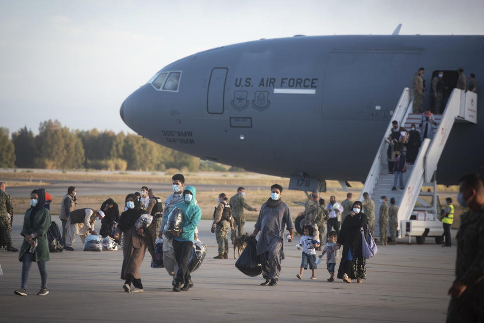 Evacuees from Afghanistan disembark from a U.S. airforce plane at the Naval Station in Rota, southern Spain, Tuesday Aug 31, 2021. The United States completed its withdrawal from Afghanistan late Monday, ending America's longest war. (AP Photo/ Marcos Moreno)