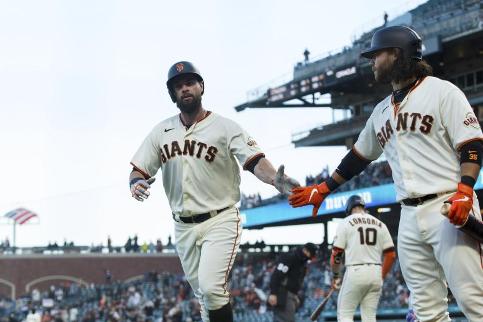 San Francisco Giants' Brandon Belt, left, celebrates with Brandon Crawford after hitting a home run.