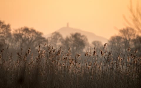 The winter sun rises over the Somerset levels near Glastonbury, as Britain braces for the 'beast from the East' - Credit: Matt Cardy/Getty Images