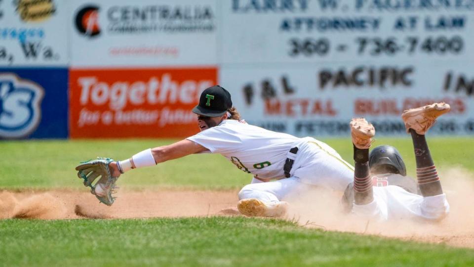 Tumwater shortstop Eddie Marson makes a diving grab on a wild throw to second as Grandview’s Carlos Guillen slides safely into the bag during the Trenton the first inning of a 2A State baseball opening round game at Wheeler Field in Centralia, Wash., on May 20, 2023.