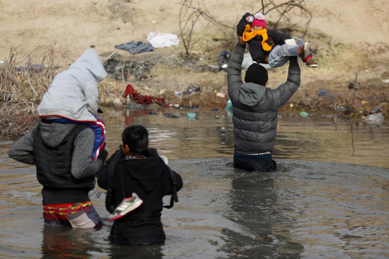 Migrants cross the Rio Grande into Texas on Tuesday from Juárez. A group of U.S. House Democrats are saying control over immigration belongs to the federal government, which makes Texas' new Senate Bill 4 immigration law unconstitutional.