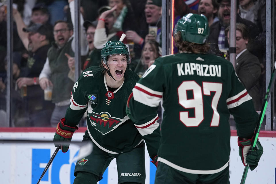 Minnesota Wild left wing Matt Boldy, left, celebrates with left wing Kirill Kaprizov (97) after scoring a goal during the third period of an NHL hockey game against the Philadelphia Flyers, Thursday, Jan. 26, 2023, in St. Paul, Minn. (AP Photo/Abbie Parr)