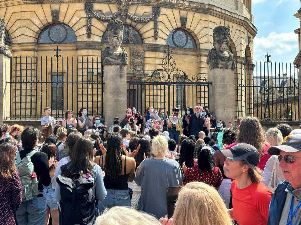Protesters chant slogans outside the Sheldonian Theatre, as the vice-chancellor of Oxford University attended a ceremony (The Independent)