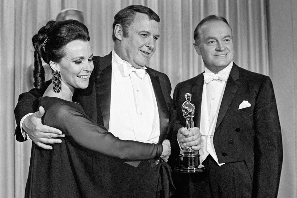 (Original Caption) 4/12/1968-Santa Monica, CA- Hugged by his wife, Claire Bloom, and congratulated by veteran Master of Ceremony, Bob Hope, Rod Steiger is shown holding his Oscar after winning Best Supporting Actor in, "In the Heat of the Night".