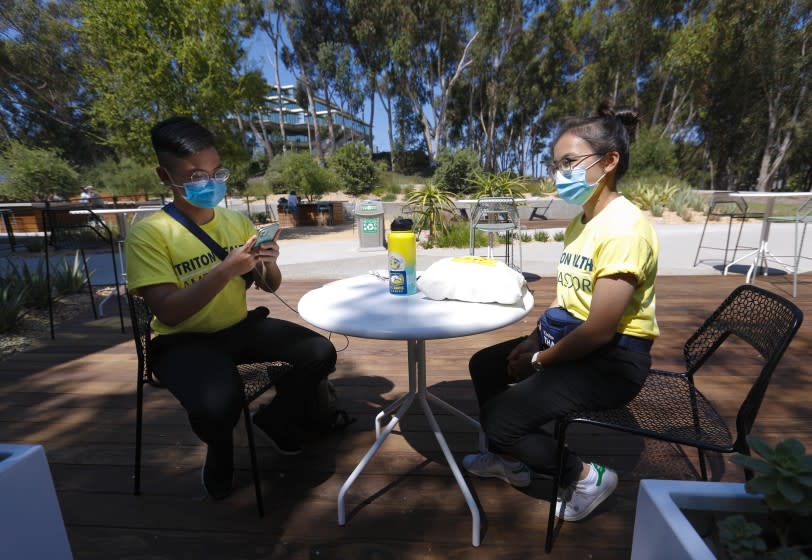 On Thursday, Sept. 24, 2020, Luan Nguyen, a UC San Diego freshman, says he earlier in the day downloaded the app to his smartphone. The software works to notify students and staff members whether theyÕve come in contact with someone who has COVID-19. Seated with Luan is his sister, sister, Diep Nguyen . (Nelvin C. Cepeda / The San Diego Union-Tribune)