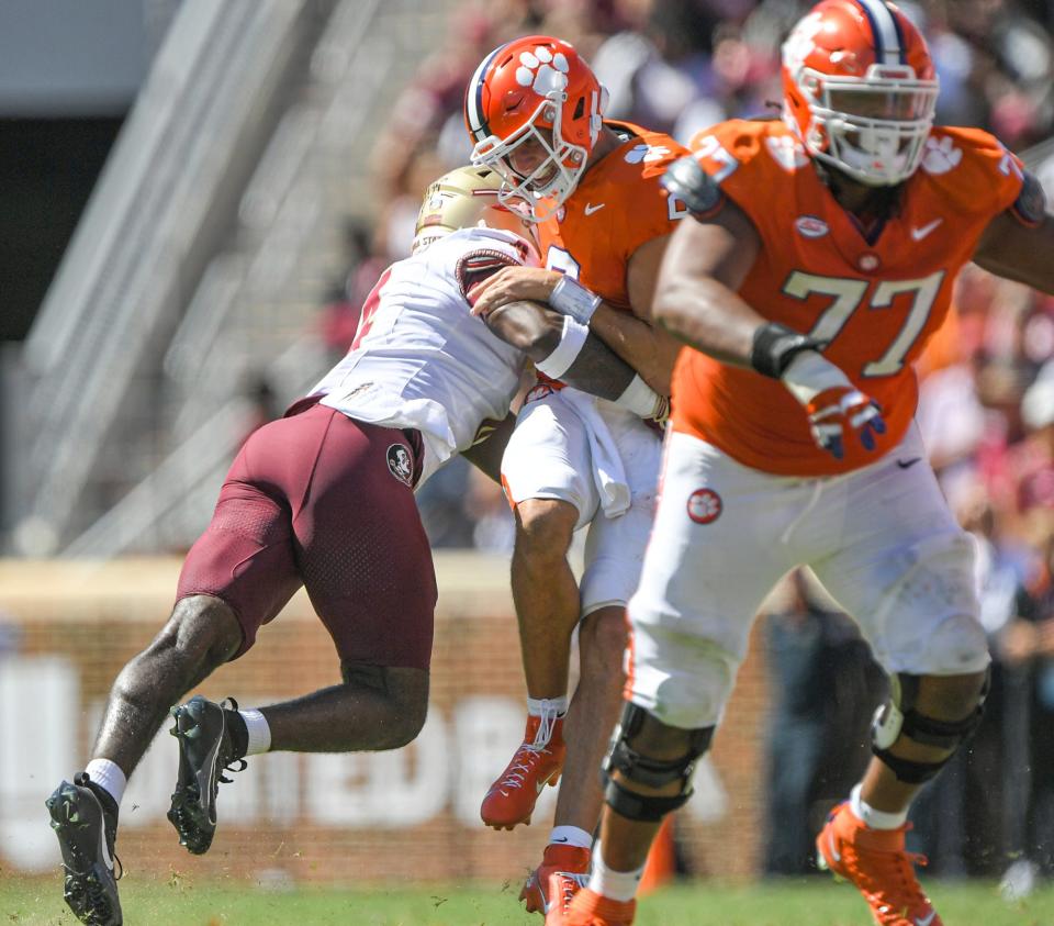 Florida State University linebacker Kalen DeLoach (4) hits Clemson quarterback Cade Klubnik (2) knocking the ball loose and picking up the fumble to run it in for a touchdown during the third quarter Sep 23, 2023; Clemson, South Carolina, USA; at Memorial Stadium.