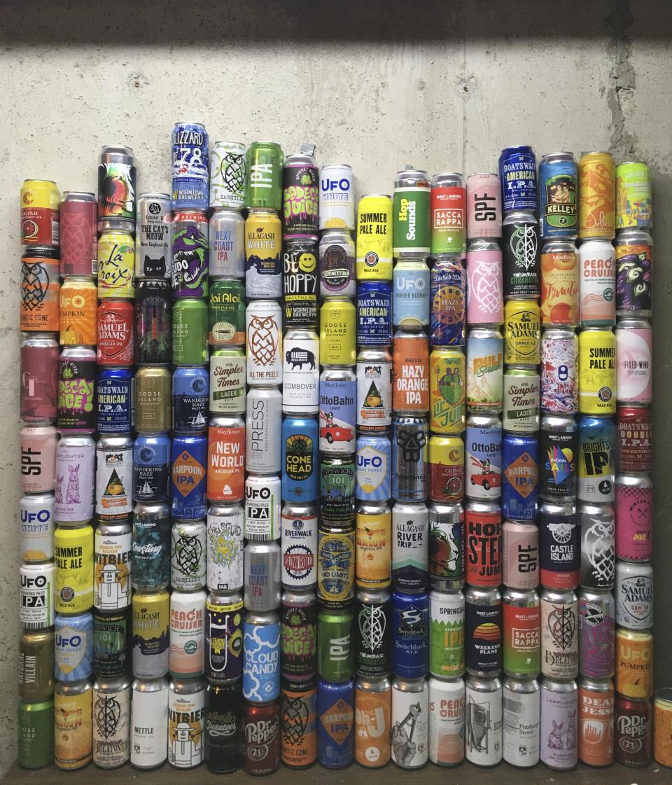 This Jan. 1, 2021 photo shows a collection of empty beer cans, consumed during the pandemic, at a home in North Andover, Mass. This year's Dry January came as many people had seen an uptick in their alcohol intake. Addiction treatment experts note that a month of forced sobriety might not have a lasting impact and could lead to binge drinking in February. But others believe the annual show of sobriety can’t hurt. (Mary Schwalm via AP)