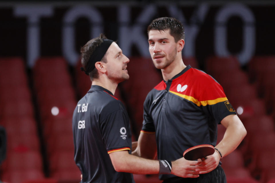 TOKYO, JAPAN - AUGUST 04: Timo Boll (L) and Dimitrij Ovtcharov (R) of Team Germany shake hands during their Men's Team Semifinals table tennis match on day twelve of the Tokyo 2020 Olympic Games at Tokyo Metropolitan Gymnasium on August 04, 2021 in Tokyo, Japan. (Photo by Steph Chambers/Getty Images)