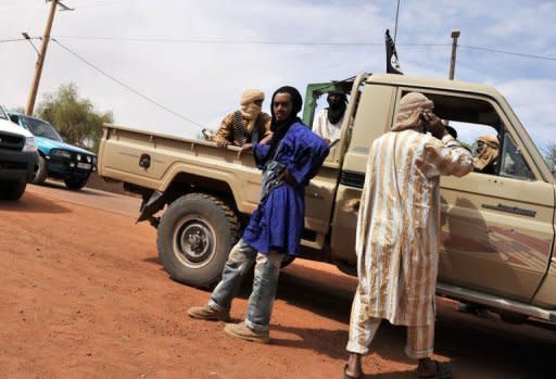 Fighters of an Islamist group Mujao guard the entrance to the hospital in Gao, northern Mali, in July 2012. The UN Security Council approved a resolution Friday that gives West African nations 45 days to offer details of a plan for international military intervention in Mali, now split in two