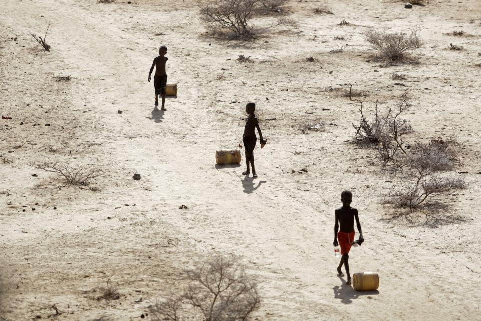 FILE - Young boys pull containers of water as they return to their huts from a well in the village of Ntabasi village amid a drought in Samburu East, Kenya, on Oct, 14, 2022. The United States has announced $524 million in additional humanitarian aid for the Horn of Africa that aims to put a spotlight on the extreme effects of climate change and the worst drought in the region in 40 years. The aid announcement also seeks to highlight the need for more than $5 billion. (AP Photo/Brian Inganga, File)