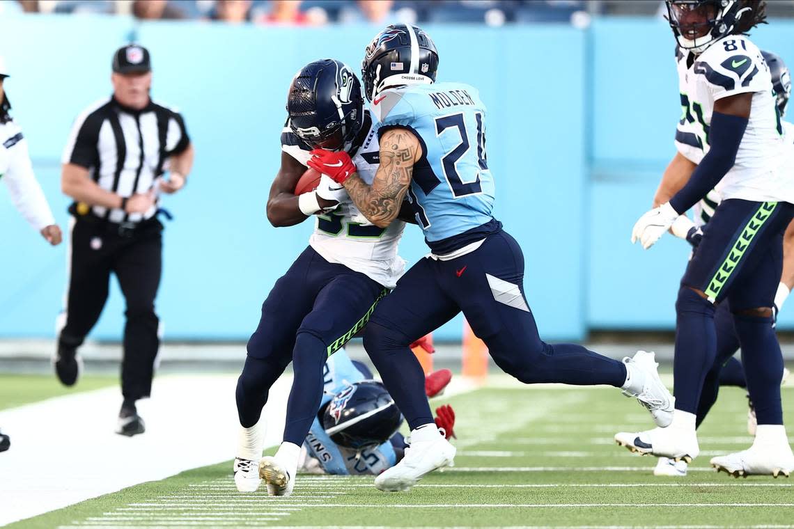 Seahawks returner Dee Williams (33) is pushed out of bounds by Tennessee Titans cornerback Elijah Molden (24) after a 41-yard gain on the opening kickoff of an NFL preseason game at Nissan Stadium in Nashville Aug. 17, 2024. Casey Gower/USA Today Sports/USA TODAY NETWORK