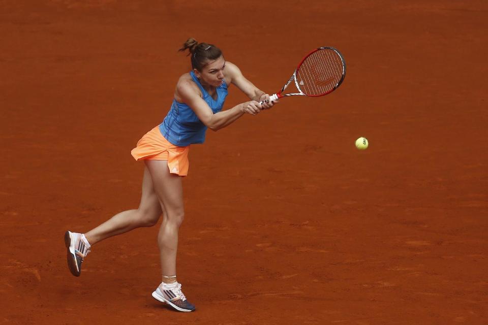 Simona Halep from Romania returns the ball to Lara Arruabarrena from Spain during a Madrid Open tennis tournament match in Madrid, Spain, Wednesday May 7, 2014. (AP Photo/Andres Kudacki)