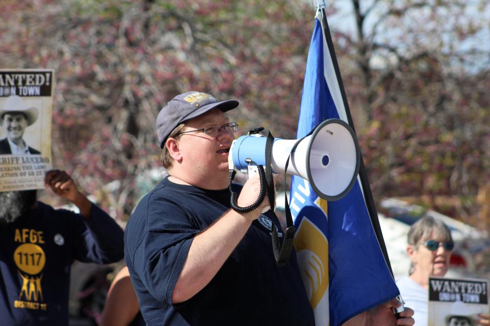 Charles Perko speaks through a megaphone during a demonstration outside the Pueblo County Sheriff's Office on Wednesday, May 1, 2024.