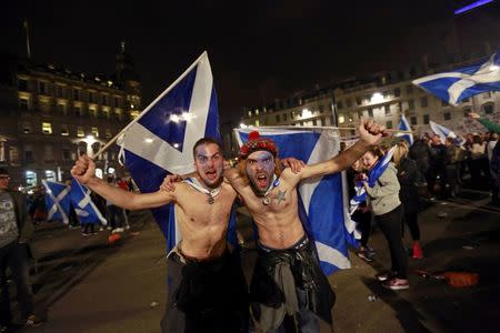 FILE PHOTO - Supporters from the "Yes" Campaign wave Scottish Saltire flags in central Glasgow September 18, 2014. REUTERS/Cathal McNaughton/File Photo