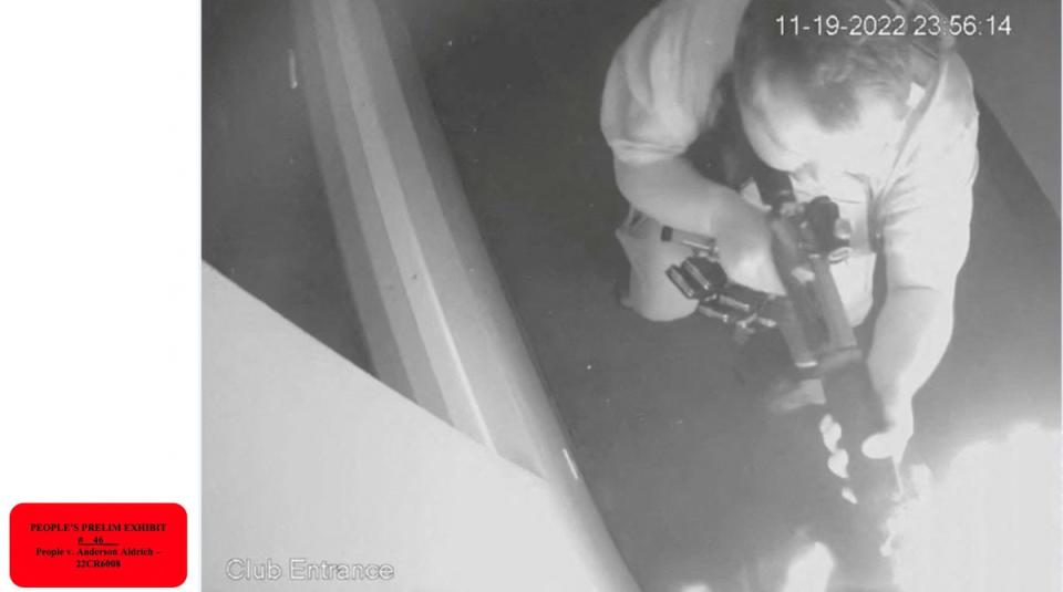 A black-and-white overhead view of Anderson Lee Aldrich firing a weapon into the LGBTQ nightclub Club Q (via REUTERS)