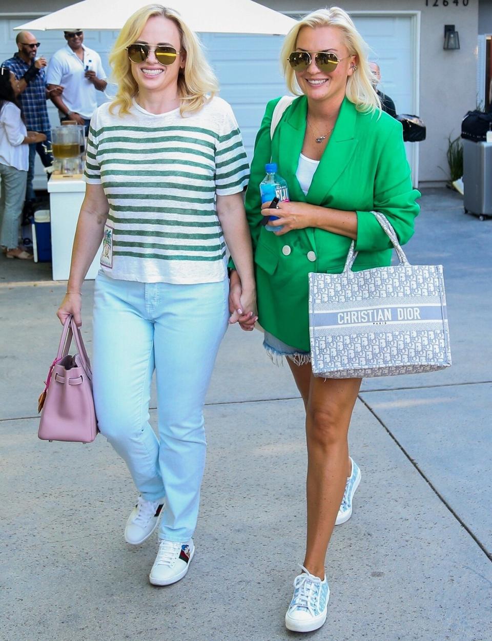 Rebel Wilson and girlfriend Ramona Agruma hold hands leaving the star-studded Day Of Indulgence party in Brentwood, CA