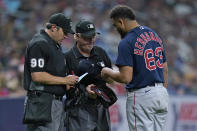 Boston Red Sox relief pitcher Darwinzon Hernandez (63) has his equipment checked for foreign substances by umpires Mark Ripperger (90), and Tom Hallion after being taken out of the game against the Tampa Bay Rays during the eighth inning of a baseball game Thursday, June 24, 2021, in St. Petersburg, Fla. (AP Photo/Chris O'Meara)