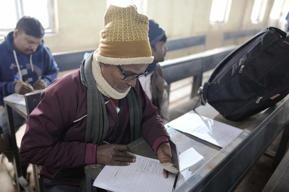 An Indian skilled worker aspiring to be hired for a job in Israel fills a form during a recruitment drive in Lucknow, India, Thursday, Jan. 25, 2024. (AP Photo/Rajesh Kumar Singh)