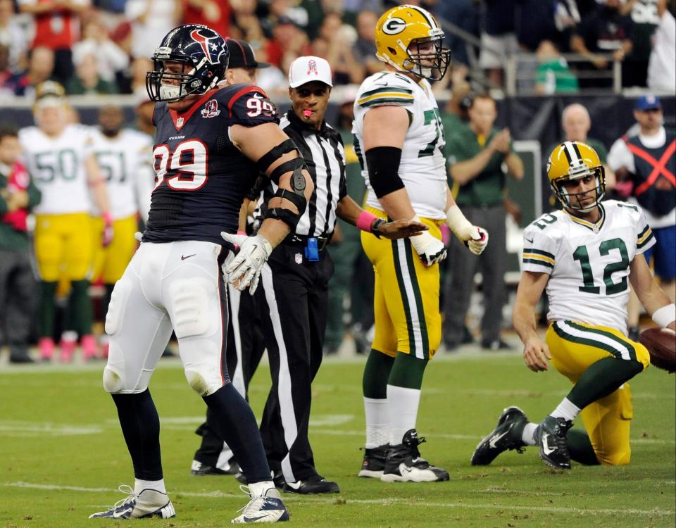 Houston Texans defensive end J.J. Watt (99) mimics Green Bay Packers quarterback Aaron Rodgers' (12) celebration pose after sacking Rodgers in the first quarter of an NFL football game, Sunday, Oct. 14, 2012, in Houston.