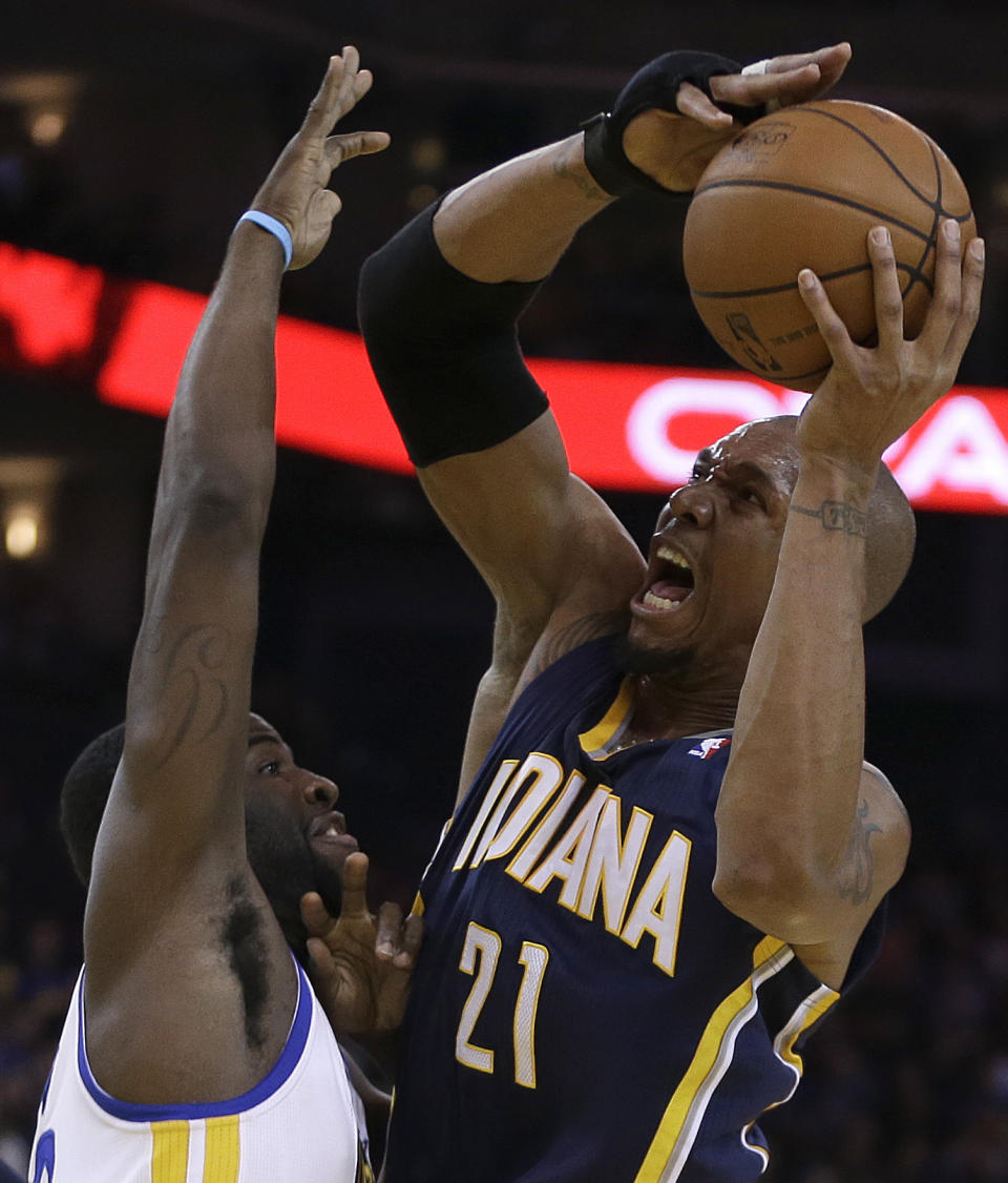 Indiana Pacers' David West, right, looks to shoot over Golden State Warriors' Draymond Green during the second half of an NBA basketball game Monday, Jan. 20, 2014, in Oakland, Calif. (AP Photo/Ben Margot)