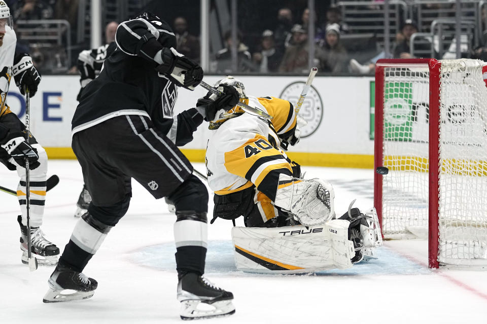 Los Angeles Kings right wing Adrian Kempe, left, scores on Pittsburgh Penguins goaltender Dustin Tokarski for his third goal of the game for a hat trick during the second period of an NHL hockey game Saturday, Feb. 11, 2023, in Los Angeles. (AP Photo/Mark J. Terrill)